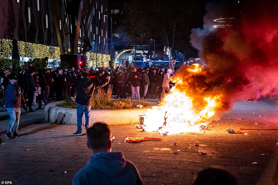 50724869-10223105-Pictured_A_scooter_set_on_fire_during_a_protest_against_the_2G_p-a-54_1637364097299.jpeg