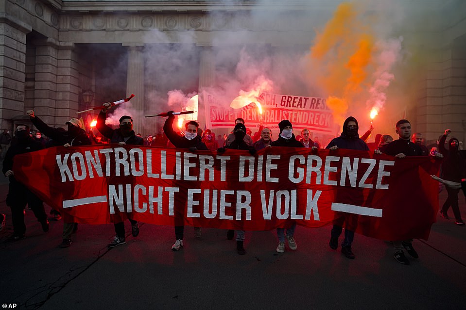 50746831-10226551-AUSTRIA_Protesters_carrying_a_banner_reading_Control_the_border_-a-8_1637520736351.jpeg