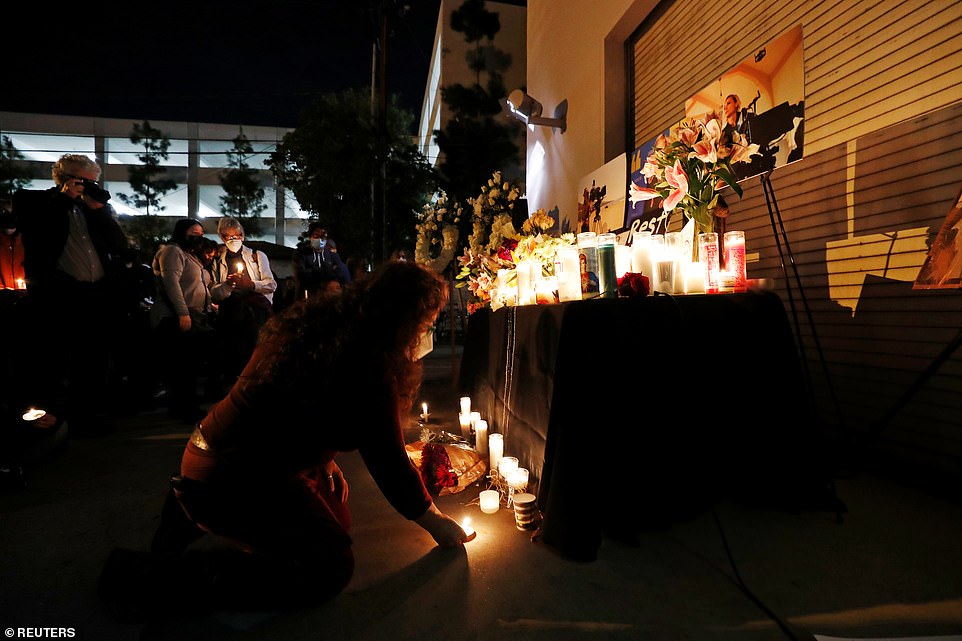 49599909-10127317-Lisa_Walker_places_a_candle_during_a_vigil_for_late_cinematograp-a-18_1635161333136.jpg