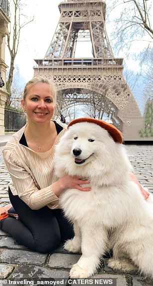 54851187-10568859-Oxana_and_one_of_her_dogs_by_the_Eiffel_Tower_in_Paris_-m-40_1646223468828.jpg