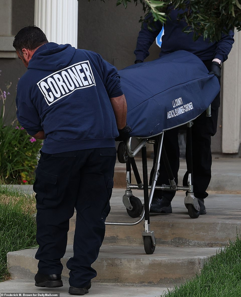 64234297-11394235-A_coroner_brings_Aaron_Carter_s_body_out_from_his_home_in_Lancas-m-7_1667699142038.jpg